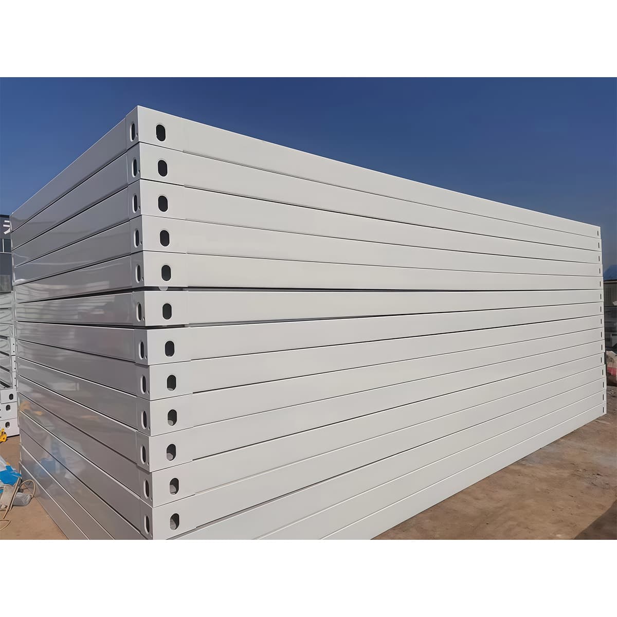 Detachable container house unit with door open, staged inside a production warehouse