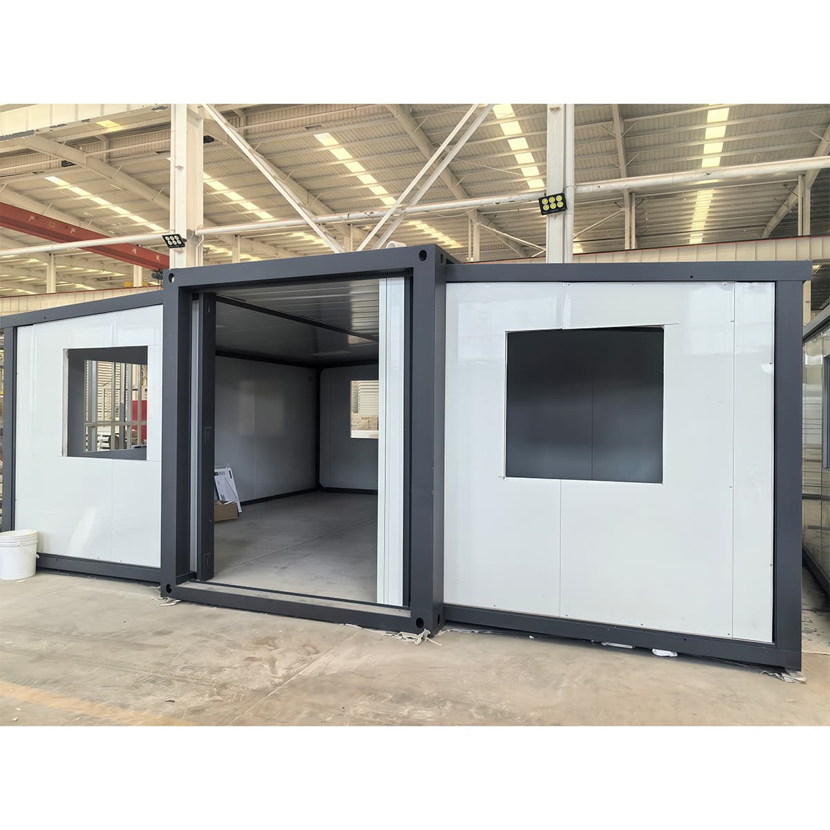 Two-storey modular building formed from expanded container modules with a glazed entrance canopy