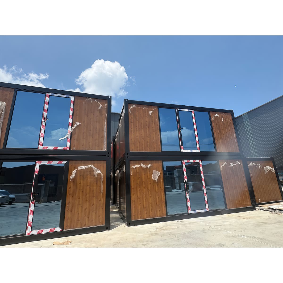 Complete group of portable rest cabins with glazed doors, windows, and timber-look wall panels