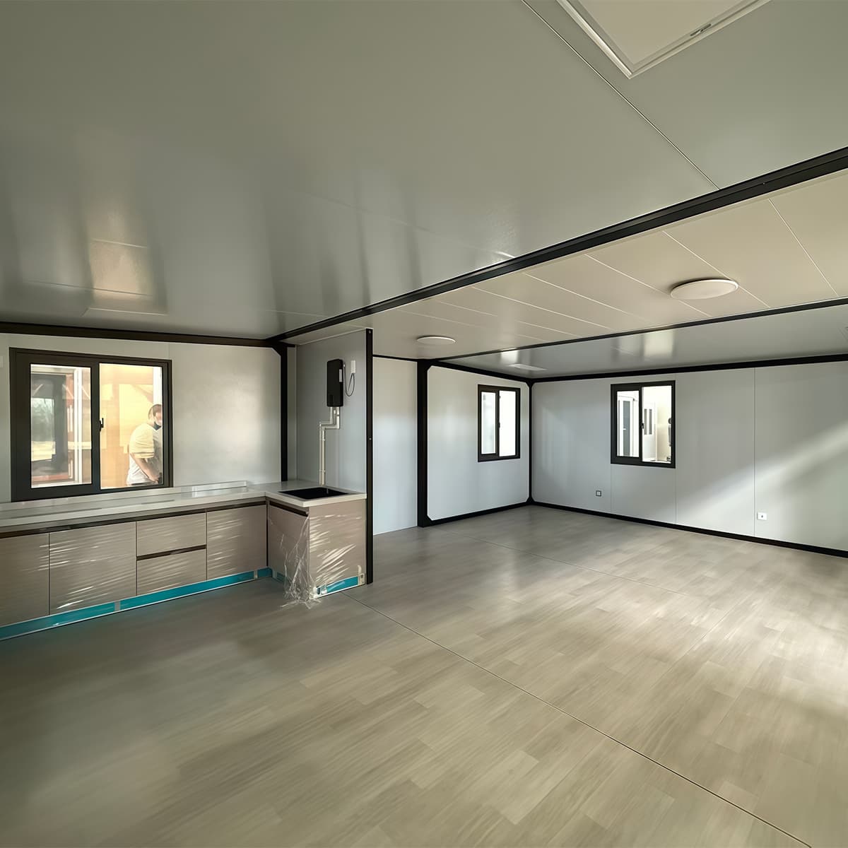 Fold-out kitchen module interior with fitted worktop, sink, and cabinetry
